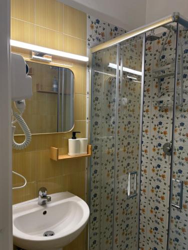 a bathroom with a sink and a shower at Dolce Vita House in Pontecagnano
