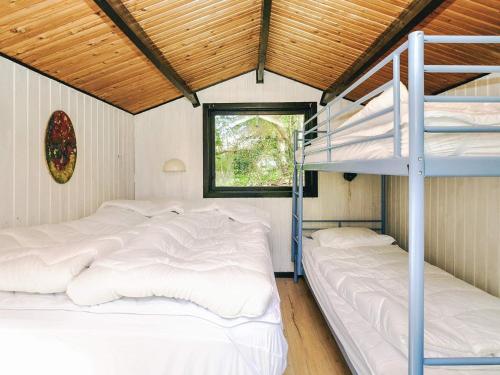 a bedroom with two bunk beds and a window at 4 star holiday home in Gørlev in Gørlev