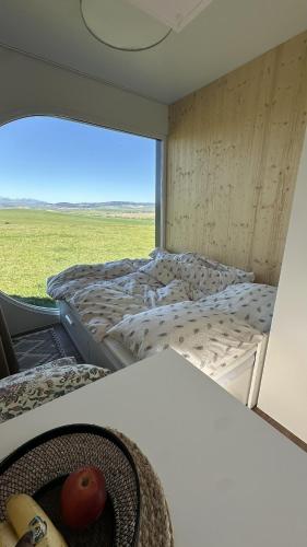 a room with two beds and a table with an apple at EkoHniezdo Slovenský Raj in Smižany