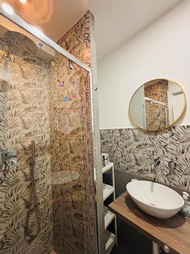 a bathroom with a sink and a mirror at Il filo di Claudia in Savona