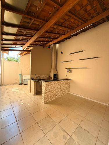 a large room with a counter in the middle at Casa Cambuí Molina in Franca
