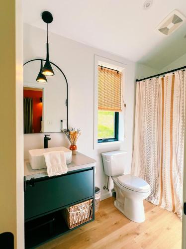 a bathroom with a sink and a toilet at Bison Farm - Cabin "Loma" in Culpeper