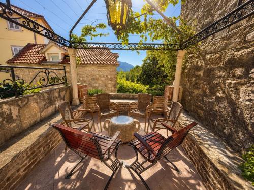 a patio with chairs and a table and a table and chairs at Hidden Garden Stone House Private Romantic Retreat in Budva Old Town in Budva