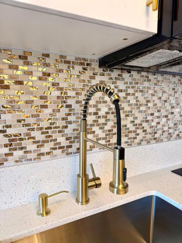 a kitchen sink with a faucet on a counter at Inn On The Park in Honolulu