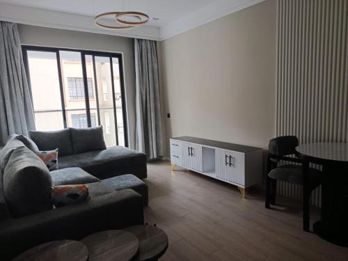 a living room with a couch and a table at Leo residences 1 in Eldoret