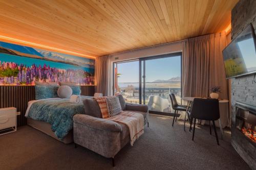 a bedroom with a bed and a large window at Aurora Vista - Ohana in Lake Tekapo