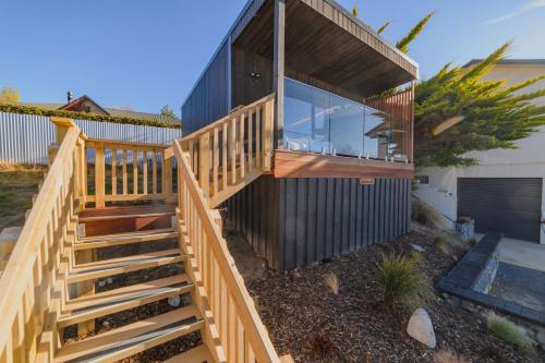 a wooden staircase leading up to a house at Aurora Vista - Ohana in Lake Tekapo