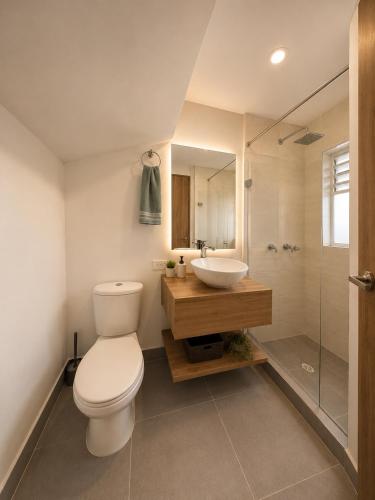 a bathroom with a toilet and a sink and a shower at Casa Edén 95 in Ricaurte