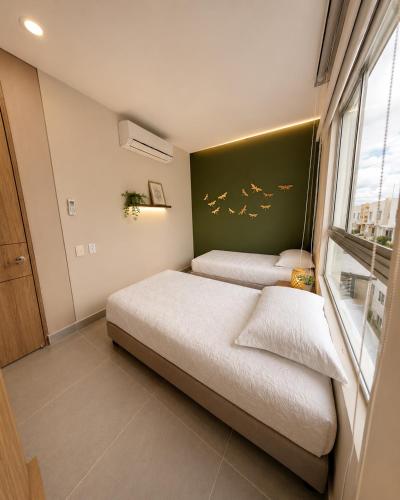 a bedroom with two beds and a window at Casa Edén 95 in Ricaurte