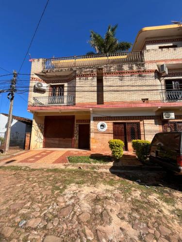 a house with a car parked in front of it at Monoambiente Ejecutivo in Villarrica