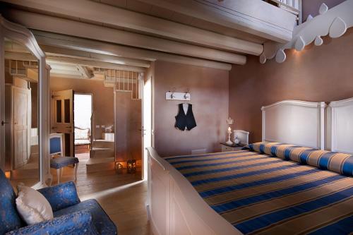 a bedroom with a bed with a striped bedspread at Boutique Hotel Villa dei Campi in Gavardo
