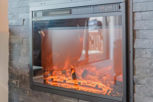 a fire in a brick oven with flames at Starlight Escape - Ohana in Lake Tekapo
