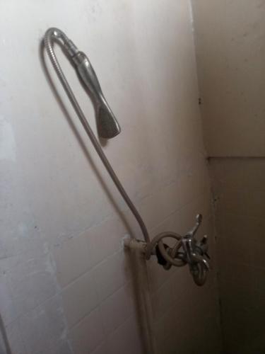 a shower head in a shower stall in a bathroom at Chepclean in Kelimutu