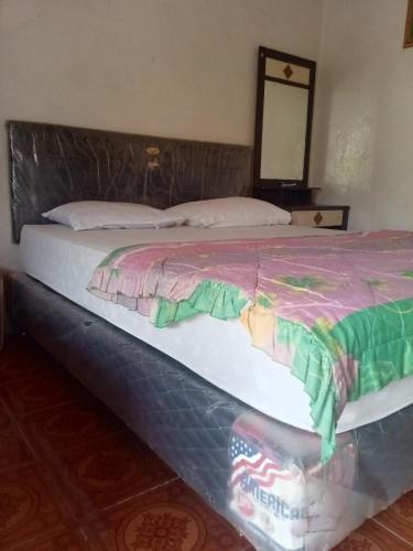 a bed in a room with at Chepclean in Kelimutu