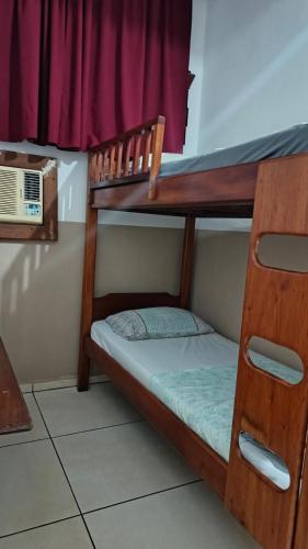 a couple of bunk beds in a room at Pousada Taiwan in Ubatuba