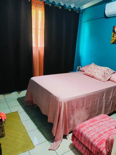 a bedroom with a pink bed and a window at Rancho María in San Diego