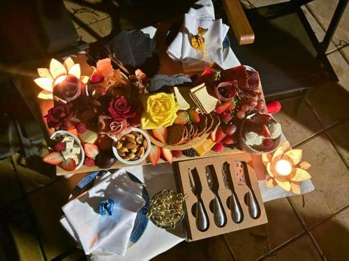 a table with many different types of food on it at Montville Retreat by Tiny Away in Montville