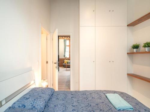 a bedroom with a bed and a living room at Stylish Duplex for 6 in Antwerp in Antwerp