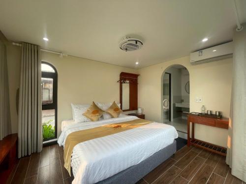 a bedroom with a large bed and a bathroom at Châu Anh House in Ðố Sơn