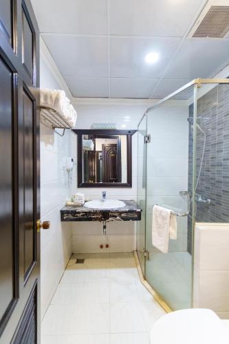 a bathroom with a sink and a shower at Royal Dalat Hotel in Da Lat