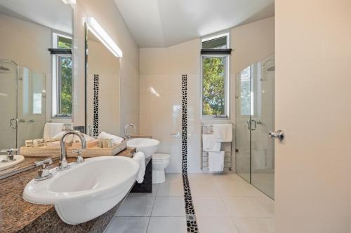 a bathroom with two sinks and a shower at Bushland in Halls Gap