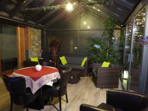 a dining room with a table and chairs and a table and chairsktop at B&B Nord Sud in Salmchâteau