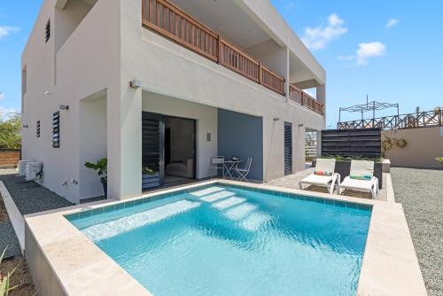 a swimming pool in the backyard of a house at Villa Anosia Laman i Tera in Westpunt