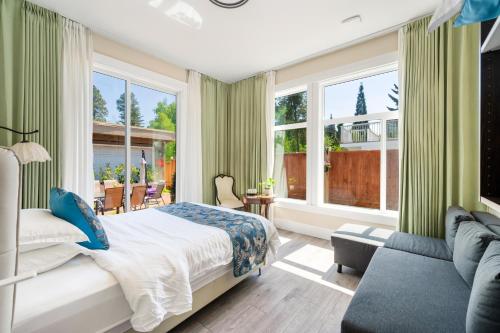 una camera da letto con un letto, un divano e finestre di Amy Guesthouse a Richmond