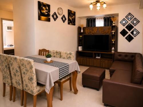 a living room with a table and a couch at Davao City Stay at Camella Northpoint Spacious 3BR Condo 5Beds Up to 10 Guests in Davao City