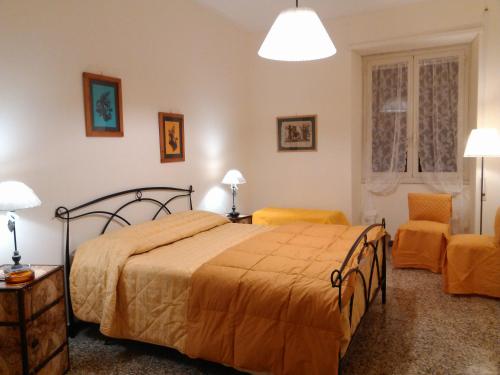 a bedroom with a bed and two orange chairs at Il Vostro Comfort in Rome