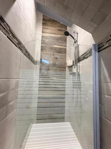 a bathroom with a shower and a staircase at Sci ZLR in Saint-Étienne