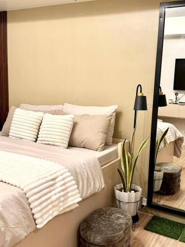 a bedroom with a bed with a mirror and a plant at Casa Primo in Biñan