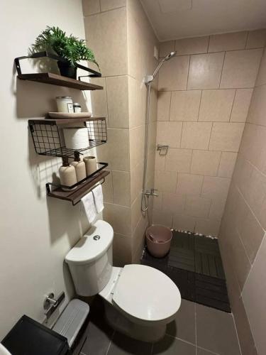a bathroom with a white toilet and a shower at Casa Primo in Biñan