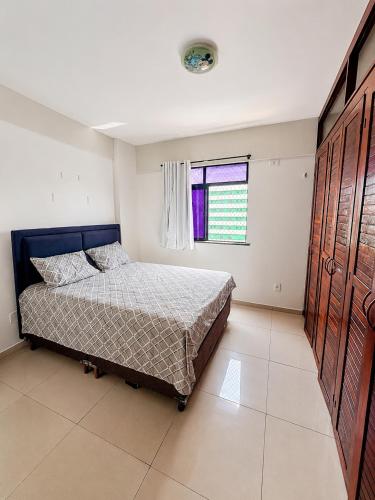 a bedroom with a bed and a window at Ocean Tower in São Luís