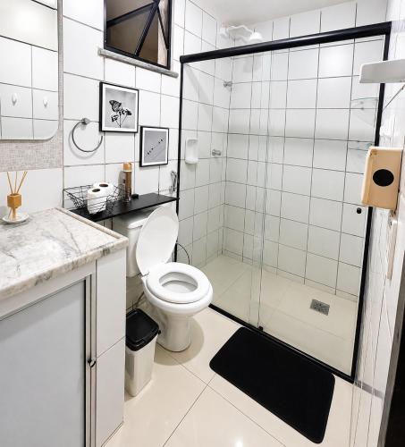a bathroom with a toilet and a glass shower at Ocean Tower in São Luís