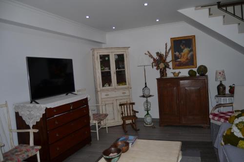a living room with a tv on a dresser at Quinta Manel da Gaita in Torres Novas