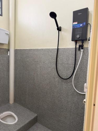 a bathroom with a toilet in a stall at Lanisa Staycation Mesra in Kampong Padang Bungor