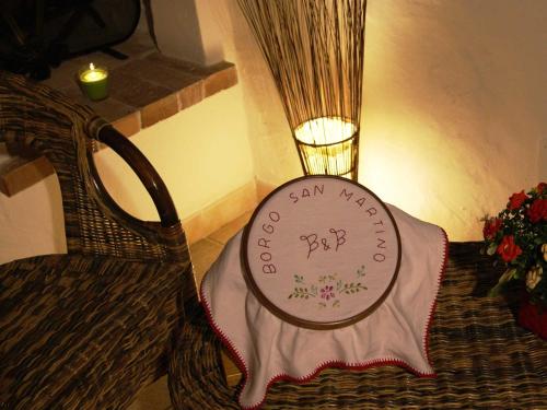 a sign on the side of a chair with a candle at B&B Borgo San Martino in Monopoli