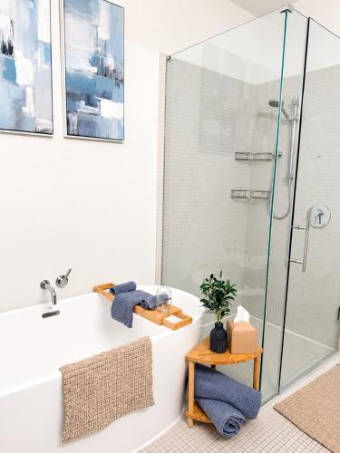 a bathroom with a tub and a glass shower at Sapphire Loft Midtown in Atlanta