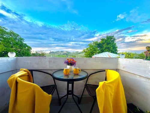 a table and two chairs on a balcony at Getaway Nook in Dedoplis Tskaro