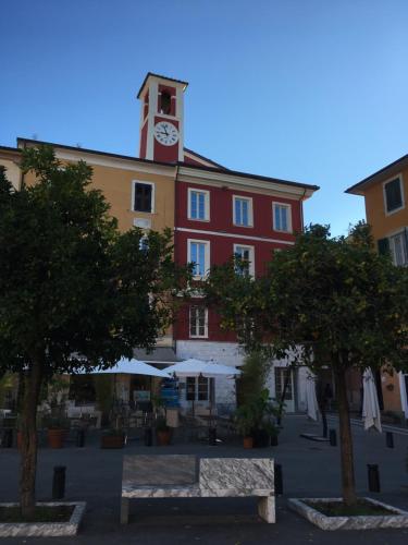 a building with a clock tower on top of it at Ostello Palazzo Nizza in Massa