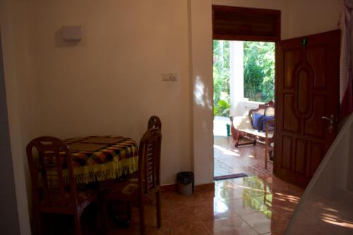 a room with a bed and a living room at Happy Coconut in Unawatuna