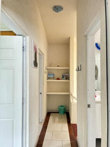 a hallway with a white door and a tile floor at House check-in anytime after 3 pm in Jurica