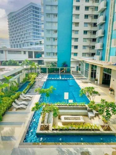 an overhead view of a swimming pool in a building at D&J Cozy Family Studio Bacolod City in Bacolod
