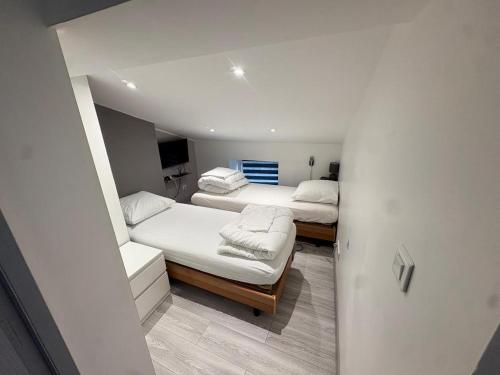 a room with two beds and a couch at Sci ZLR in Saint-Étienne