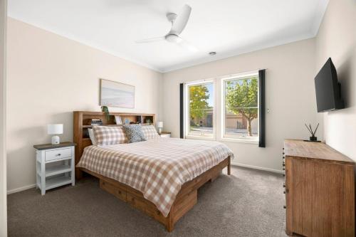 a bedroom with a bed and a window at Modern home in Highton in Highton