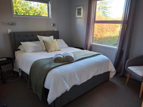 a bedroom with a bed with two slippers on it at The Coop in Kinloch