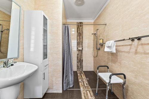 a bathroom with a shower and a sink at Kickenback Lodge - 3BR Lodge l Gym l Indoor Pool l Tennis l WiFi l Air-Con in Crackenback