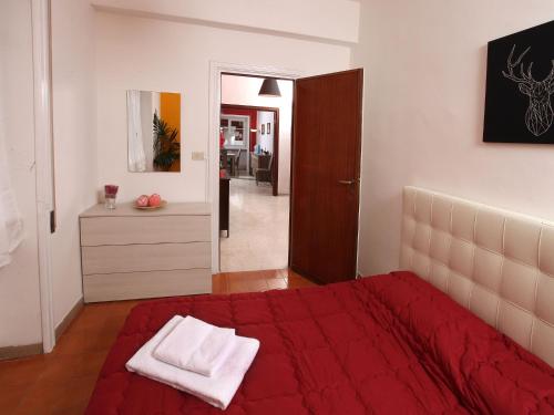 a bedroom with a bed with a red blanket at Alice Home in Rome