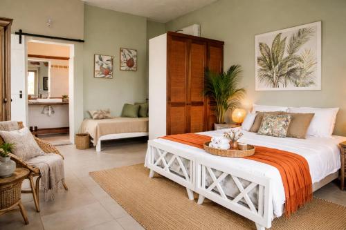 a bedroom with a large white bed in a room at Gite des Acacias in Union Vale